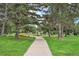 Scenic park view featuring lush green grass, mature trees, a walking path, and a playground at 7 Elati St, Denver, CO 80223