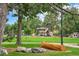 Community park with playground, green grass, and log bench at 7 Elati St, Denver, CO 80223