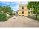 Outside concrete parking area, fenced, with a view of the yellow building at 7 Elati St, Denver, CO 80223