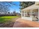 Backyard with brick patio and enclosed sunroom offers outdoor entertaining at 2975 S Jackson St, Denver, CO 80210