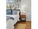 Bedroom detail showing bedside table, soft lighting, and comfortable bed at 2975 S Jackson St, Denver, CO 80210