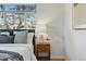 Close up of a bedroom bedside table, including a lamp and plant at 2975 S Jackson St, Denver, CO 80210