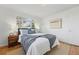 Inviting bedroom featuring a comfortable bed, hardwood floors, and a large window at 2975 S Jackson St, Denver, CO 80210