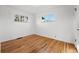 An empty bedroom with hardwood floors and natural light from two windows at 2975 S Jackson St, Denver, CO 80210