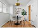Cozy dining room with hardwood floors, a round table, and modern lighting fixture at 2975 S Jackson St, Denver, CO 80210