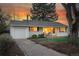 Charming home featuring a well-maintained lawn, a cozy front porch, and an attached one car garage at 2975 S Jackson St, Denver, CO 80210