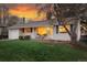 Charming home featuring a well-maintained lawn, a cozy front porch, and an attached one car garage at 2975 S Jackson St, Denver, CO 80210