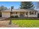 Charming home featuring a well-maintained lawn, a cozy front porch, and an attached one car garage at 2975 S Jackson St, Denver, CO 80210