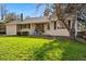 Charming home featuring a well-maintained lawn, a cozy front porch, and an attached one car garage at 2975 S Jackson St, Denver, CO 80210