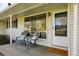 Inviting front porch with a seating area, a welcome mat, and an exterior light at 2975 S Jackson St, Denver, CO 80210