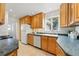 Bright kitchen with wood cabinets, tile floor, and stainless steel appliances at 2975 S Jackson St, Denver, CO 80210