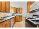Charming kitchen featuring wood cabinets, appliances, tile backsplash and tile flooring at 2975 S Jackson St, Denver, CO 80210