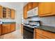 Close up view of kitchen featuring a range, microwave and upper cabinets at 2975 S Jackson St, Denver, CO 80210