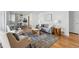 Open-concept living room showcases a comfortable sofa, modern decor, area rug, and dining area at 2975 S Jackson St, Denver, CO 80210