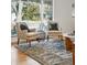 Close up view of the living room area with comfortable seating near a large window at 2975 S Jackson St, Denver, CO 80210