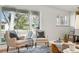 Bright living room area with comfortable seating and a view of the yard through the large window at 2975 S Jackson St, Denver, CO 80210