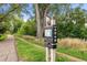 The High Line Canal sign at Eisenhower Park in Denver displays maps and directions on a tree-lined trail at 2975 S Jackson St, Denver, CO 80210