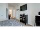 Bedroom featuring bathroom access, and modern entertainment setup at 5723 N Gibralter Way # 205, Aurora, CO 80019