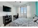 Modern bedroom with stylish black and white bedding, a workstation, and natural light at 5723 N Gibralter Way # 205, Aurora, CO 80019