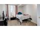 Well-lit bedroom featuring neutral walls, comfy bed, and a large window for natural light at 5723 N Gibralter Way # 205, Aurora, CO 80019