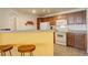 Efficient kitchen featuring a breakfast bar and white appliances at 5723 N Gibralter Way # 205, Aurora, CO 80019