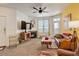 Bright living room featuring a cozy fireplace and a large window for natural light at 5723 N Gibralter Way # 205, Aurora, CO 80019