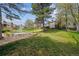Expansive backyard featuring a large fountain, mature trees, and green lawn at 6917 E Girard Ave, Denver, CO 80224