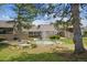 Tranquil backyard view showcasing the water fountain and beautiful lush green grass at 6917 E Girard Ave, Denver, CO 80224