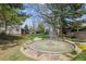 Spacious backyard features a water fountain, mature trees, and green lawn at 6917 E Girard Ave, Denver, CO 80224