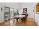 Elegant dining room featuring hardwood floors, a patio sliding door, and a view into the kitchen at 6917 E Girard Ave, Denver, CO 80224