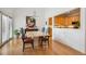Bright dining room featuring hardwood floors and a view into the adjacent kitchen at 6917 E Girard Ave, Denver, CO 80224