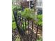 Well-maintained garden with black iron fence and lush green plants at 6917 E Girard Ave, Denver, CO 80224