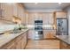 Bright kitchen features stainless steel appliances, granite countertops, and wooden cabinetry at 6917 E Girard Ave, Denver, CO 80224