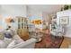 Open living area showcasing hardwood floors, stylish seating, and seamless flow into the adjacent kitchen at 6917 E Girard Ave, Denver, CO 80224