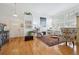 Bright living room featuring hardwood floors, high ceilings, a fireplace, and large windows at 6917 E Girard Ave, Denver, CO 80224
