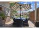 Outdoor patio with dining furniture under a shaded umbrella for relaxation and entertainment at 6917 E Girard Ave, Denver, CO 80224