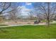 Community playground features a swing set and slide with green grass and a sidewalk at 6917 E Girard Ave, Denver, CO 80224