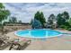 Large, in-ground pool with lounge chairs on the pool deck, surrounded by mature trees at 6917 E Girard Ave, Denver, CO 80224