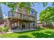 Multi-level backyard featuring a wooden deck, patio, and lush green lawn at 9552 E Caley Cir, Englewood, CO 80111