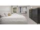 Bright bedroom featuring a comfortable bed, large window, stylish dresser, and decorative art at 9552 E Caley Cir, Englewood, CO 80111