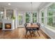 Bright dining room featuring hardwood floors, a fireplace, and access to the backyard deck at 9552 E Caley Cir, Englewood, CO 80111