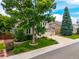 Charming home with mature trees, landscaped front yard, and a well-maintained lawn showcasing curb appeal at 9552 E Caley Cir, Englewood, CO 80111