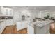 Spacious kitchen featuring white cabinets, granite countertops, stainless steel appliances and hardwood floors at 9552 E Caley Cir, Englewood, CO 80111