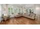 Open concept living room featuring hardwood floors, large windows with shutters, and recessed lighting at 9552 E Caley Cir, Englewood, CO 80111