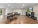 Spacious living room with hardwood floors, stylish seating, and entertainment center at 9552 E Caley Cir, Englewood, CO 80111