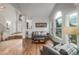 Inviting living room with soaring ceilings, hardwood floors, and abundant natural light at 9552 E Caley Cir, Englewood, CO 80111