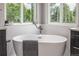 Bright main bathroom featuring a soaking tub, modern fixtures, and luxurious finishes at 9552 E Caley Cir, Englewood, CO 80111