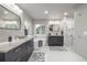 Modern main bathroom with dual vanities, a soaking tub, and a glass-enclosed shower at 9552 E Caley Cir, Englewood, CO 80111