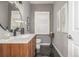 Stylish powder room with modern vanity, elegant fixtures, and patterned tile flooring at 9552 E Caley Cir, Englewood, CO 80111