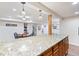 Basement showcasing a bar area with granite countertops, wood cabinets, and a unique lighting design at 250 W Midway Blvd, Broomfield, CO 80020